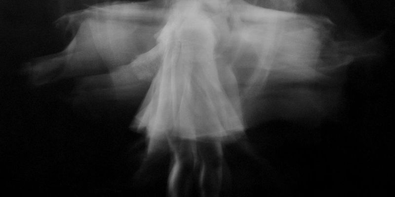 Person performing a dynamic stretching movement with blurred motion effect.