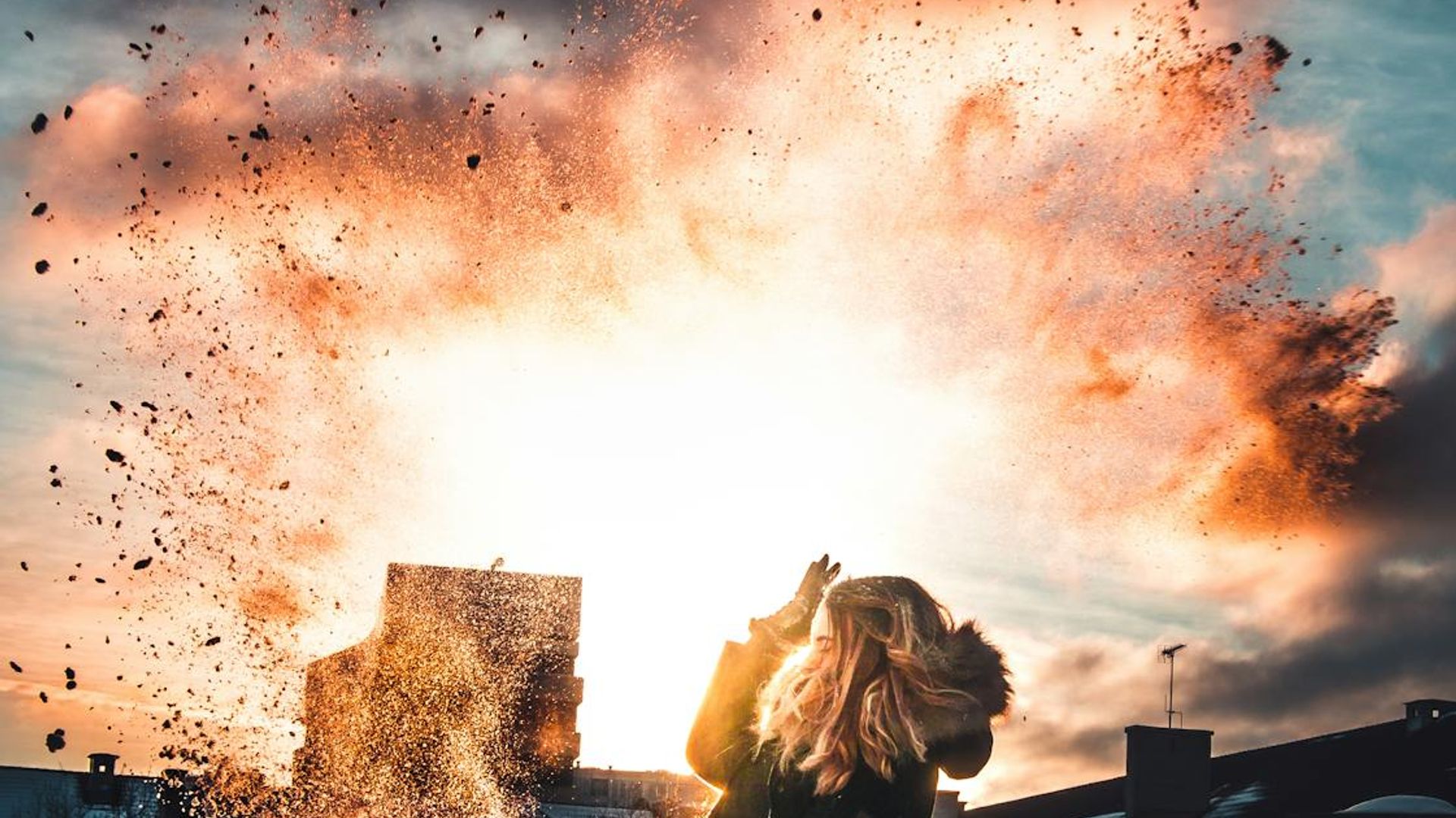 Silhouette of a person in a dynamic motion pose against a dark background with cyan light trails.